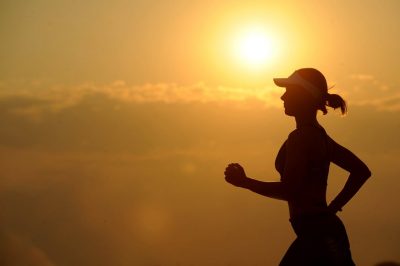 running woman jogging long distance sun
