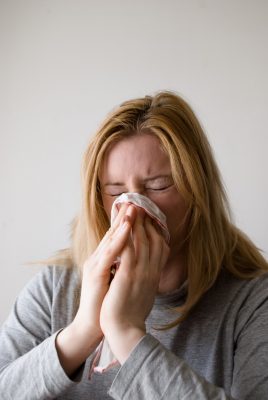 girl sick flu blowing nose